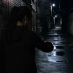 어두운 골목길에 홀로 서 있는 여성의 뒷모습